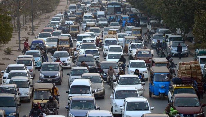 Vehicles move at slow pace due to traffic jam and closed road during protests by MWM at Rashid Minhas road in Karachi on December 30, 2024. — PPI