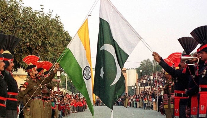 akistani border guards (right) and their Indian counterparts take part in the daily closing ceremony of the Wagah border crossing near Lahore, Pakistan. — Reuters/File