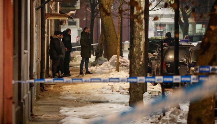 Police and security personnel stand near the scene where a gunman opened fire at a restaurant and killed several people in Cetinje, Montenegro, January 1, 2025. — Reuters