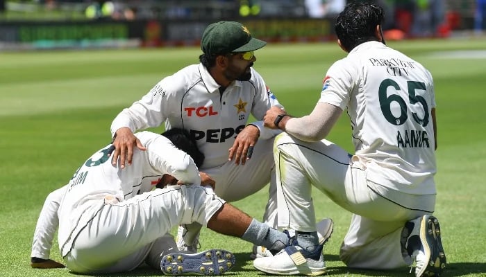 Saim Ayub (left) reacts in pain after being injured on January 3, 2025. — AFP