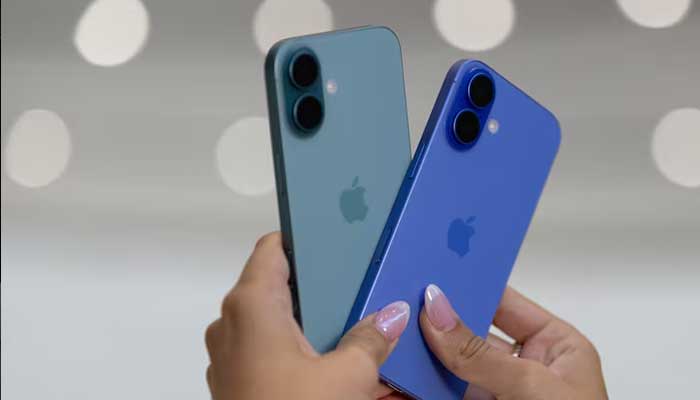 An attendee holds two iPhones 16 as Apple holds an event at the Steve Jobs Theater on its campus in Cupertino, California, US September 9, 2024. — Reuters