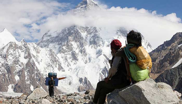 A Pakistani porter looking towards K2, world’s second tallest mountain in the Karakoram range of Gilgit–Baltistan, Pakistan, July 15, 2023. — AFP