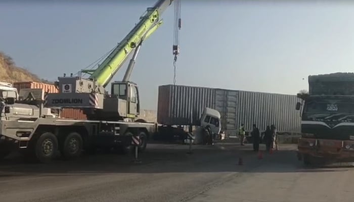 A container truck involved in the road mishap near Karachi is being removed from the highway on January 4, 2025. — Reporter