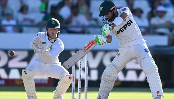 Pakistan´s Mohammad Rizwan (R) watches the ball after playing a shot as South Africa´s wicketkeeper Kyle Verreynne (L) reacts during the second day of the second Test cricket match between South Africa and Pakistan at Newlands stadium in Cape Town on January 4, 2025. — AFP