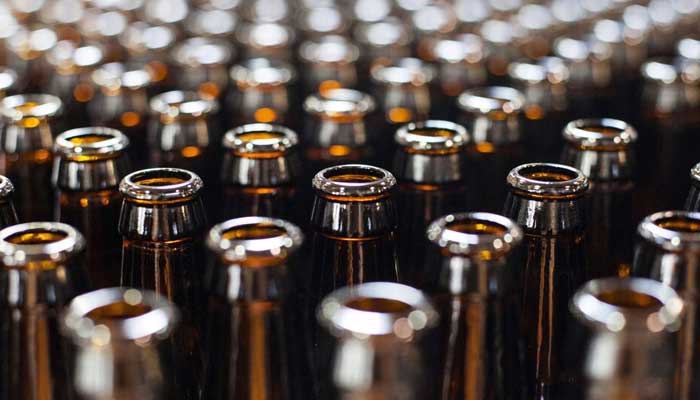 A bunch of alcohol bottles wait to be filled and labelled ahead of packaging in New York, United States, March 9, 2015. — Reuters