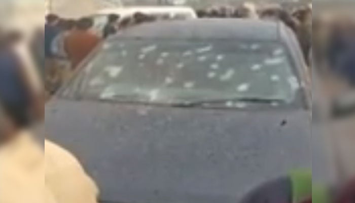 Bullet holes are visible on the widescreen of the car the victims were travelling in on January 4, 2025. —YouTube/Geo News