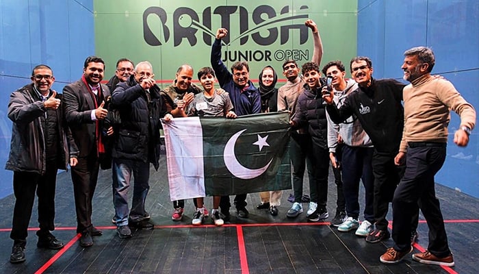 Pakistans Sohail Adnan and other officials celebrating victory with Pakistani flag at the British Junior Open Squash Championship 2025. — Reporter