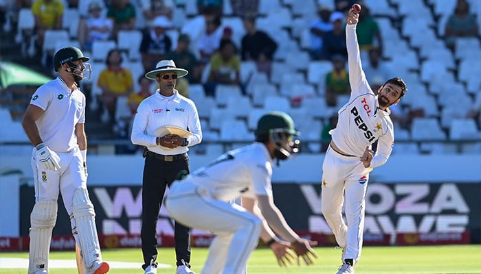 Pakistans Salman Agha (R) delivers a ball as Sri Lankan umpire Kumar Dharmasena (2nd L) and South Africas Aiden Markram (L) look on during the fourth day of the second international Test cricket match between South Africa and Pakistan at Newlands stadium in Cape Town on January 6, 2025. — AFP