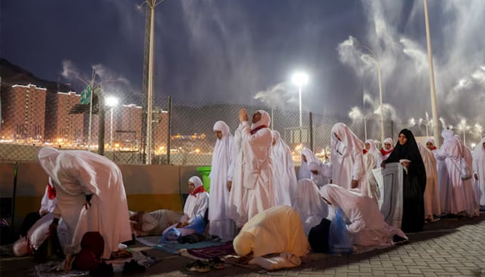 Pilgrims pray as sprinklers spray water to cool them down amid extremely hot weather, during the annual haj pilgrimage, in Mina, Saudi Arabia, June 16, 2024. — Reuters