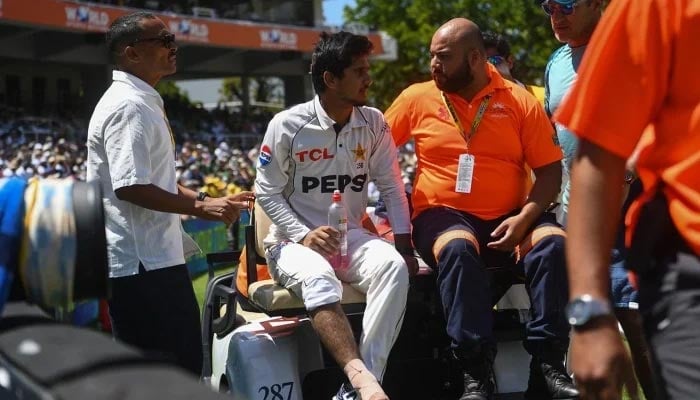 Saim Ayub is assisted off the field after being injured during the first day of the second international Test cricket match between South Africa and Pakistan at Newlands stadium in Cape Town on January 3, 2025. — AFP