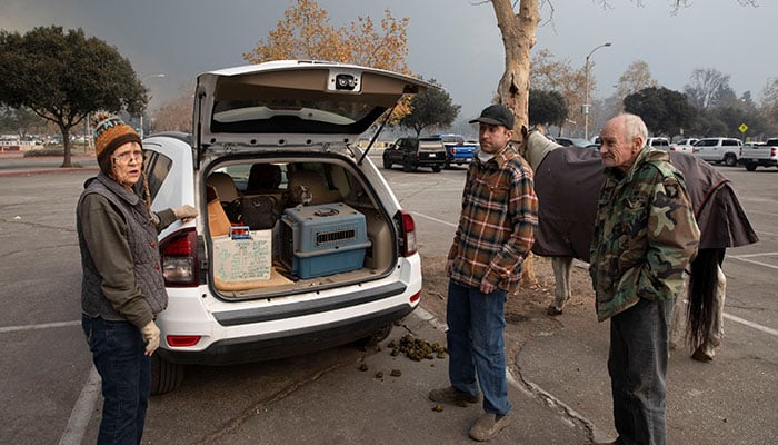 Altadena residents Patricia Stubblefield, Tim Olausen, and Greg Olausen stand after evacuating their homes with their dog, cat, and a horse, following powerful winds fueling devastating wildfires in the Los Angeles area, in Pasadena, California, US January 8, 2025. — Reuters