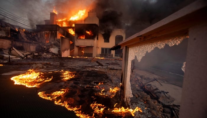 Flames and smoke rise from structures as the Palisades fire burns during a windstorm on the west side of Los Angeles, California, US, on January 8, 2025. — Reuters