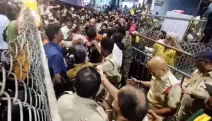 Indian police personnel try to manage the crowd at the Sri Venkateswara Swamy Temple in Andhra Pradesh, India. — ANI