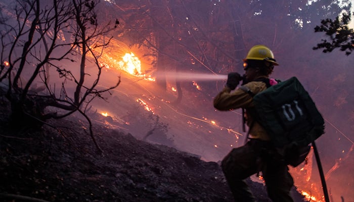 The wind whips embers while a firefighter battles the fire in the Angeles National Forest near Mt. Wilson as the wildfires burn in the Los Angeles area, during the Eaton Fire in Altadena, California, US January 9, 2025. — Reuters