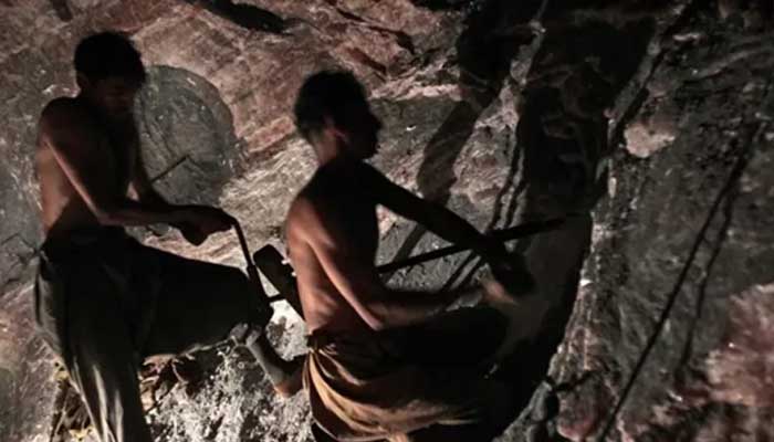 An undated image of Pakistani miners inside a coal mine. — AFP/File