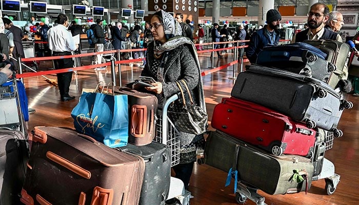 Passengers arrive at the immigration counter before boarding their Pakistan International Airlines flight to Paris at the Islamabad International Airport on January 10, 2025. — AFP