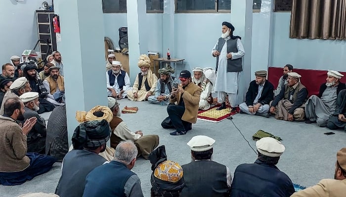 This photograph taken on December 5, 2024, shows men gathered during Jirga, a tribal council meeting, at a mosque after clashes in Parachinar, Kurram. — AFP