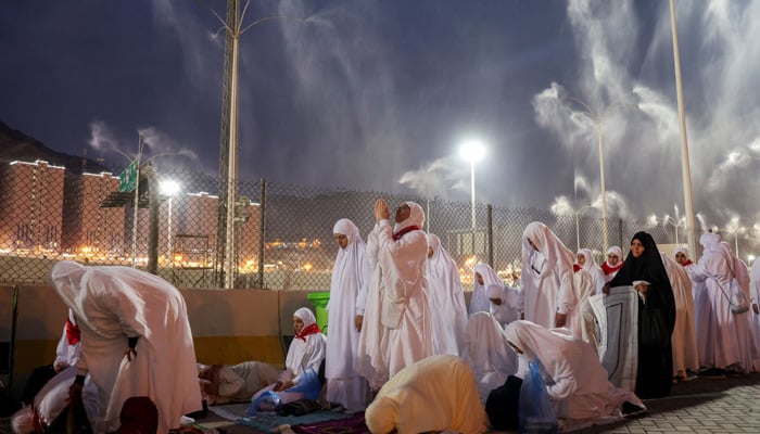 Muslim pilgrims pray as sprinklers spray water to cool them down amid extremely hot weather, during the annual haj pilgrimage, in Mina, Saudi Arabia, June 16, 2024. — Reuters