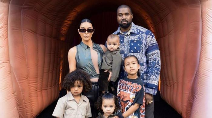 Kanye West meets youngsters in Japan whereas Kim Kardashian offers with LA wildfires