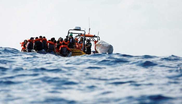 Crew members of the Geo Barents migrant rescue ship, operated by Medecins Sans Frontieres (Doctors Without Borders), distribute life jackets to a group of 61 migrants on a wooden boat during a rescue operation in international waters off the coast of Libya, in the central Mediterranean Sea September 28, 2023. — Reuters