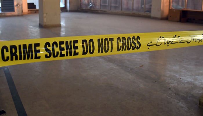 A crime scene tape can be seen at the site of a mishap in Karachi on February 18, 2023. — Online