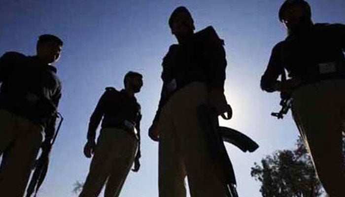 This representational image shows policemen stand guard at an unidentified location in Karachi. — AFP/File