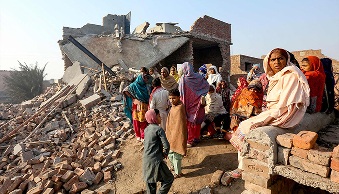 Residents gather beside their destroyed houses after an LPG tanker truck exploded near an industrial area in Multan on January 27, 2025. — AFP