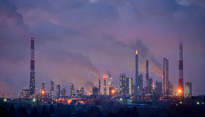 Flue gas and steam rise out of chimneys and smokestacks of an oil refinery during sunset on a frosty day in the Siberian city of Omsk, Russia, February 8, 2023. — Reuters