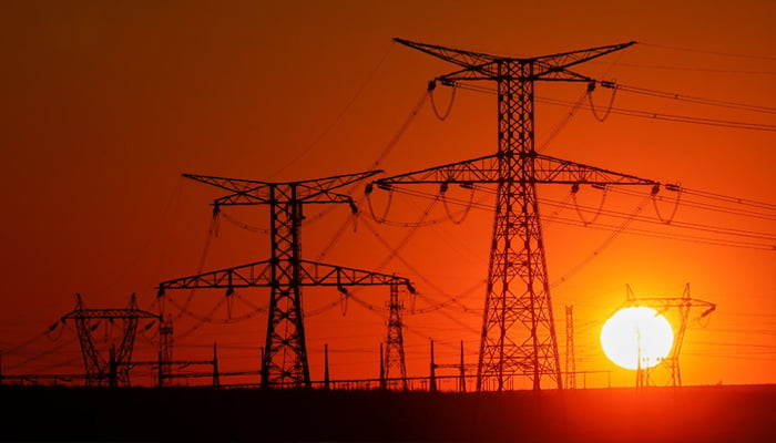 Electricity towers from high-voltage electrical lines are seen during sunset, in Gavril, near Arras, France, April 3, 2023.-Reuters