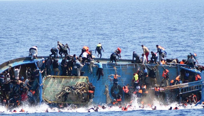 Migrants attempt to save themselves after their boat capsized. — Reuters/File