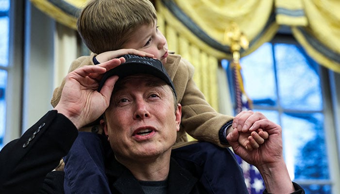 Elon Musk speaks as he carries X Æ A-12 on his shoulders next to U.S. President Donald Trump (not pictured) in the Oval Office of the White House in Washington, D.C., US, February 11, 2025. — Reuters