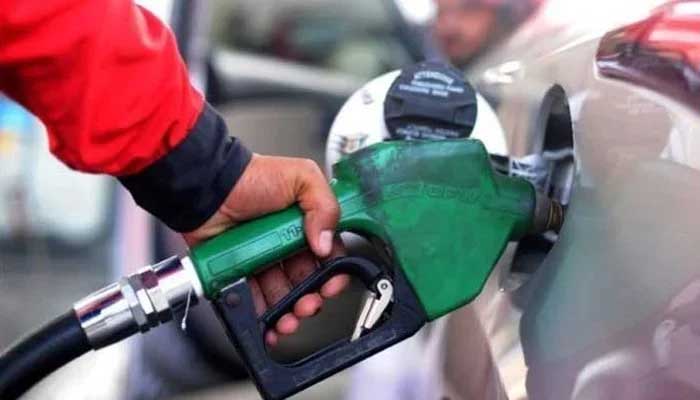 A fuel station worker holds a petrol nozzle at a petrol pump. — Reuters/File