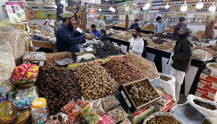 People buy dry fruits at a market in Karachi, Pakistan February 1, 2023.— Reuters