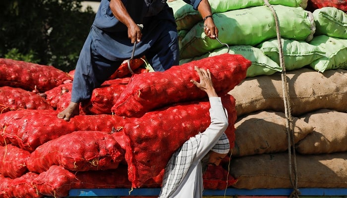 Labourers unload sacks of onion from a truck to supply at a market in Karachi, Pakistan February 1, 2023.