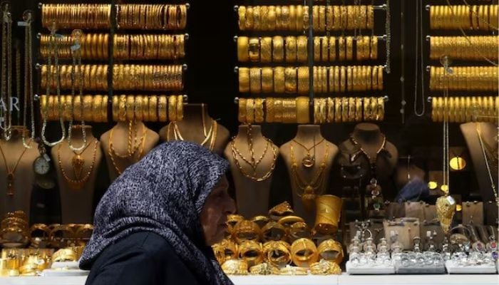 A woman passes by a gold shop, following the results of the second round of the presidential election, in Ankara, Turkey May 29, 2023. — Reuters