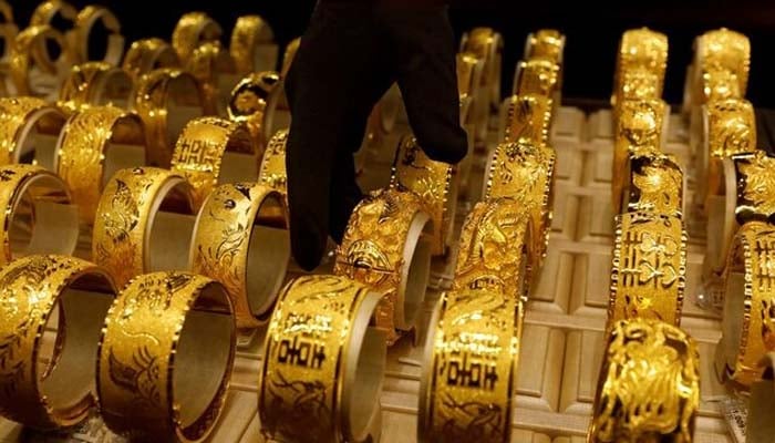 A salesperson arranges 24K gold bracelets for Chinese weddings at Chow Tai Fook Jewellery store in Hong Kong, China.— Reuters/File