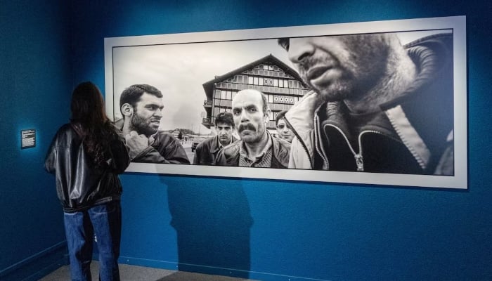 A patient, who is a part of a project in which doctors prescribe museum visits, looks at a photograph by Michael von Graffenried in the Art and History Museum in Neuchatel, Switzerland March 11, 2025. — Reuters